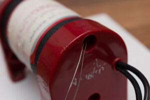 Paper clips through the bolt hole of the back cover Hobbico TorqMaster 90